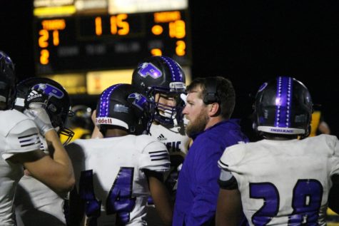 Gathered on the sidelines, the team prepares to mount their offensive attack. 